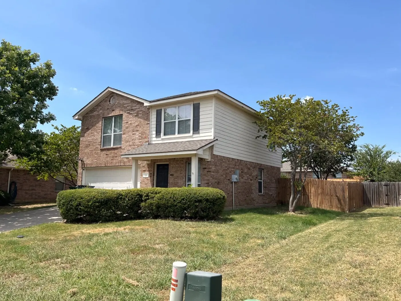 Two-story brick house, bought by Tara Pays Cash