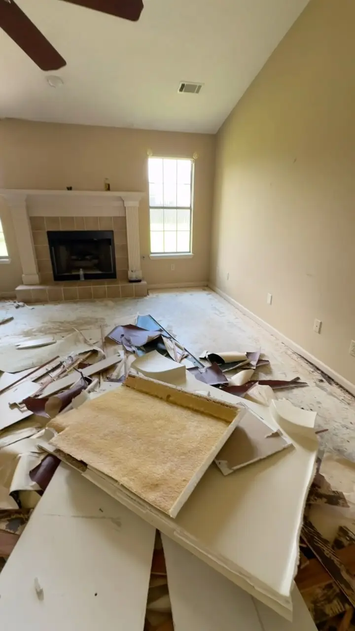 Demolition debris piled in a living room during a rehab